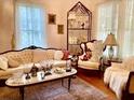 Bright living room featuring antique furniture and hardwood floors at 116 Morral, Walterboro, SC 29488