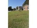 Large front yard with mature trees and a spacious lawn at 8520 Delhi Rd, North Charleston, SC 29406