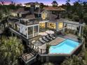 Luxury home with pool and spacious deck at dusk at 1913 Mooring Line Way, Mount Pleasant, SC 29466