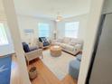 Bright living room with comfy seating, a coffee table, and hardwood floors at 32 41St Ave, Isle of Palms, SC 29451