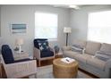 Cozy living room featuring a sofa, armchairs, and a wicker coffee table at 32 41St Ave, Isle of Palms, SC 29451