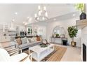 Open living room with kitchen views, hardwood floors, and a cozy seating area at 1118 Burkets Bend Ln, Charleston, SC 29492