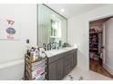 Modern bathroom with double vanity, large mirror, and a walk-in closet at 9 Iron Frg Aly, Charleston, SC 29403