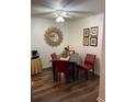 Dining room with dark wood table, red chairs, and a sunburst mirror at 2150 Spoleto Ln # B-3, North Charleston, SC 29406