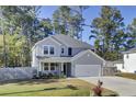 Two-story home with gray siding, two-car garage, and fenced yard at 687 W Butternut Rd, Summerville, SC 29483