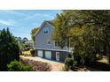 Rear view showing three car garage and landscaping at 4233 Haulover Dr, Johns Island, SC 29455