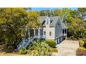 Two-story home with driveway and detached garage at 4233 Haulover Dr, Johns Island, SC 29455
