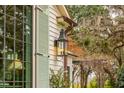 Exterior detail of the house, showcasing a lantern and window with shutters at 4285 Clover Hill Rd, Green Pond, SC 29446