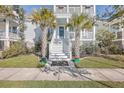 Two-story house with front porch and palm trees at 2600 Josiah St, Charleston, SC 29492