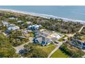 Aerial view showcasing a house, pool, and oceanfront community at 1735 Atlantic Ave, Sullivans Island, SC 29482