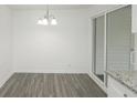 Simple dining area with neutral walls, hardwood floors, and a sliding glass door at 211 Water Wheel Rd, Ridgeville, SC 29472