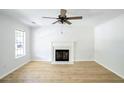 Bright living room featuring hardwood floors, a fireplace, and a ceiling fan at 3233 Queensgate Way, Mount Pleasant, SC 29466