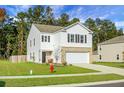 Two-story house with white siding, brick bottom, and two-car garage at 370 Spruce Ivy St, Moncks Corner, SC 29461