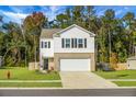 Two-story house with white siding, brick accents, and a two-car garage at 370 Spruce Ivy St, Moncks Corner, SC 29461