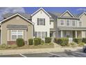 Two story townhome with neutral siding and landscaping at 102 Woodward Rd, Goose Creek, SC 29445