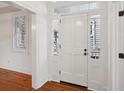 Bright entryway with white door, hardwood floors, and plantation shutters at 175 Wentworth St # A, Charleston, SC 29401