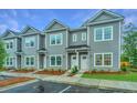 Gray townhouses with white doors and landscaping at 1103 Twin Rivers Drive # 71, Wando, SC 29492