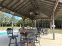 Covered patio with seating area overlooking the pool at 6300 Badham Dr, Reevesville, SC 29471