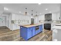 Modern kitchen with white cabinets, blue island, and copper sink at 4429 Francis Younge Way, Hollywood, SC 29449