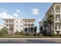 Two-story building with balconies, palm trees, and manicured landscaping at 325 Longshore St # 1123, Daniel Island, SC 29492