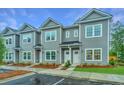 Gray townhouses with white trim, landscaping, and parking at 701 Twin Rivers Dr # 41, Wando, SC 29492