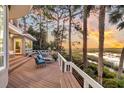 Deck with wooden seating and beautiful sunset marsh views at 169 Marsh Island Dr, Kiawah Island, SC 29455