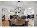 Bright dining area with wood table and gray chairs, an open concept kitchen and living room at 700 Daniel Ellis Dr # 13301, Charleston, SC 29412