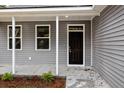 Dark brown front door with sidelights and a porch at 164 Aleene Drive Dr, Summerville, SC 29485