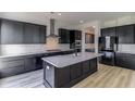 Modern kitchen with dark cabinetry and quartz island at 218 Symphony Ave, Summerville, SC 29486