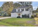 Two-story white house with gray roof, red door, and attached garage at 1600 Windsor Ln, Moncks Corner, SC 29461