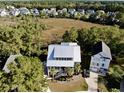 Aerial view of a house in a neighborhood near a marsh at 1999 N Creek Dr, Mount Pleasant, SC 29466