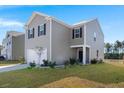Two-story home with a two-car garage, landscaping, and a pond view at 728 Ladywood Dr, Summerville, SC 29486