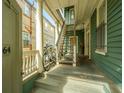 Front porch with white columns and wooden stairs at 64 Radcliffe St, Charleston, SC 29403