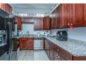 Well-equipped kitchen with dark wood cabinets and granite counters at 64 Radcliffe St, Charleston, SC 29403