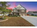 Two-story house with stone accents, double garage, and landscaped yard at 551 Rosings Dr, Summerville, SC 29486