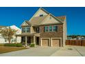 Two-story house with stone accents, double garage, and landscaped yard at 551 Rosings Dr, Summerville, SC 29486