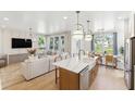 Open concept kitchen with island, stainless steel appliances, and white cabinets at 297 Claret Cup Way, Charleston, SC 29414