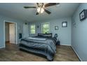 Main bedroom with ceiling fan and wood-look floors at 565 Estates Dr, Walterboro, SC 29488