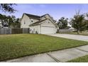 Two-story house with a two-car garage and fenced yard at 174 Education Blvd, Ladson, SC 29456
