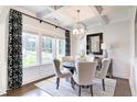 Formal dining area with coffered ceilings, hardwood floors, and large windows at 462 Rowley Ln, Summerville, SC 29486