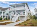 Two-story light purple house with white trim, double garage, and front porch at 2312 Bucktail Ct, Mount Pleasant, SC 29466