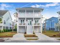 Two-story light purple house with white trim, double garage, and front porch at 2312 Bucktail Ct, Mount Pleasant, SC 29466