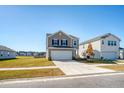 Two-story home with taupe siding, white garage door, and landscaping at 487 Pender Woods Dr, Summerville, SC 29486