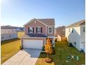 Two-story home with taupe siding, white garage door, and landscaping at 487 Pender Woods Dr, Summerville, SC 29486