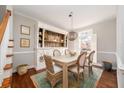 Bright dining room with a rustic farmhouse table, wicker chairs, and a large hutch at 1328 Southlake Dr, Mount Pleasant, SC 29464