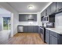 Modern kitchen with stainless steel appliances and gray cabinets at 2503 S Hwy 17A, Summerville, SC 29483