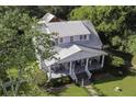 House with a metal roof, porch, and landscaped yard; detached barn at 8517 Lodge Hwy, Lodge, SC 29082