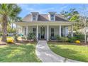 Charming house with a welcoming front porch and landscaped yard at 318 Simmons Ave, Summerville, SC 29483