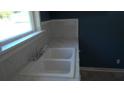 White double kitchen sink with marble countertop and blue walls at 8266 N Highway 17, McClellanville, SC 29458