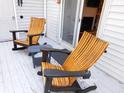 Relaxing deck with two wooden rocking chairs and a small side table at 265 Sea Cloud Cir, Edisto Island, SC 29438